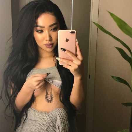 Nikita Dragun shows off her dragon head sternum tattoo.